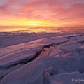 A fiery sunrise paints the ice purple along the Lake Erie shoreline near the Marblehead Lighthouse in Ottawa County.