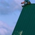 Amish Carpenter on Roof at Barn Raising